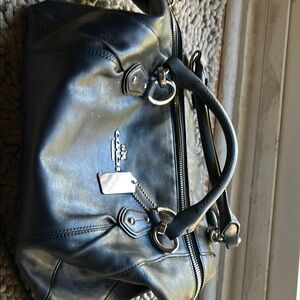 Coach - guaranteed Good used condition no rips or tears. It's a medium size.